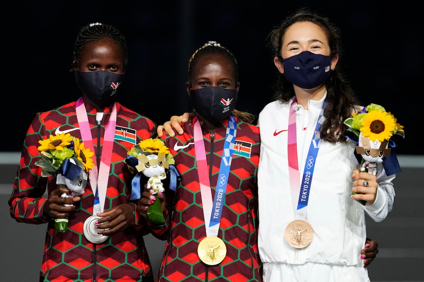 The three medallists in the women's marathon after being given bouquets and medals during the Tokyo Olympics closing ceremony. 