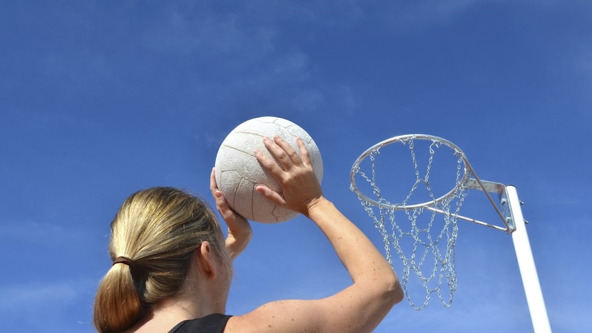 Woman playing netball.