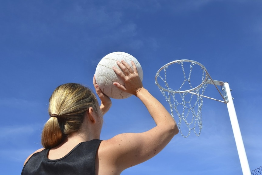 Woman playing netball.