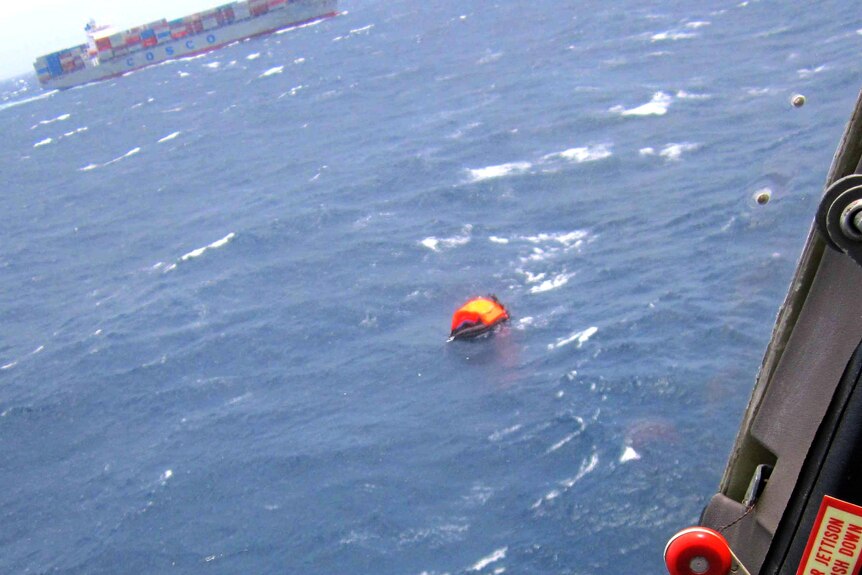 An inflatable life raft full of the survivors of the MV Rabaul Queen sinking drift in the ocean.