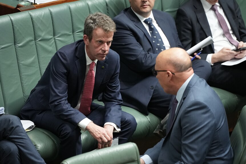 Dan Tehan and Peter Dutton talk during question time