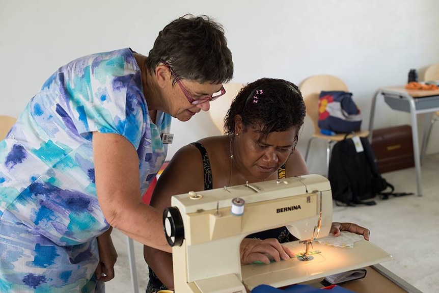 Caroline Mason works on a sewing machine in Vanuatu.