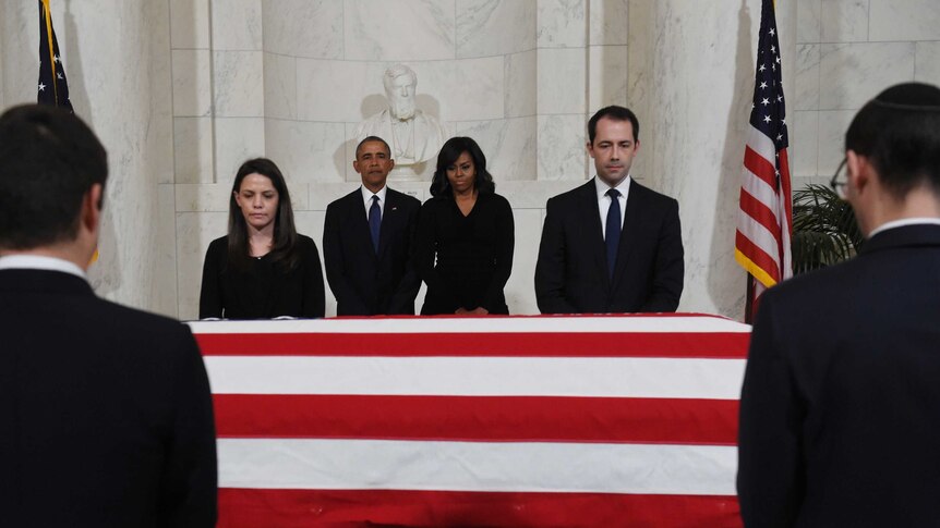 Barack Obama and First Lady Michelle Obama pay their respects