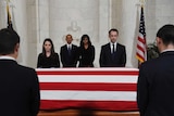 Barack Obama and First Lady Michelle Obama pay their respects