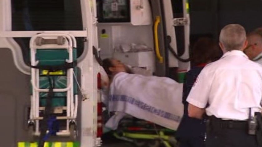 A man stabbed in a home invasion arrives in an ambulance at Royal Perth Hospital.