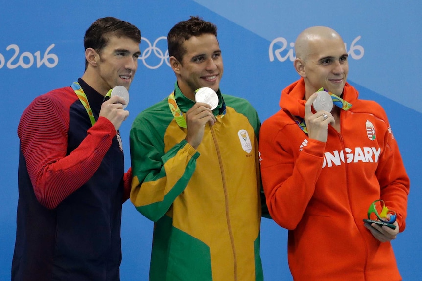 Three silver 100m butterfly silver medallists on the dias