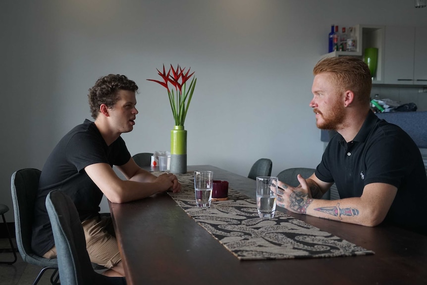 Two bar workers sitting at a table.