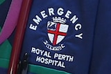 A close up of a doctor wearing an emergency department uniform with a stethoscope around her neck.