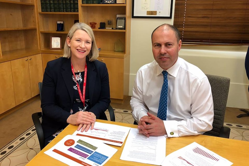 Two treasurers sit together at a desk