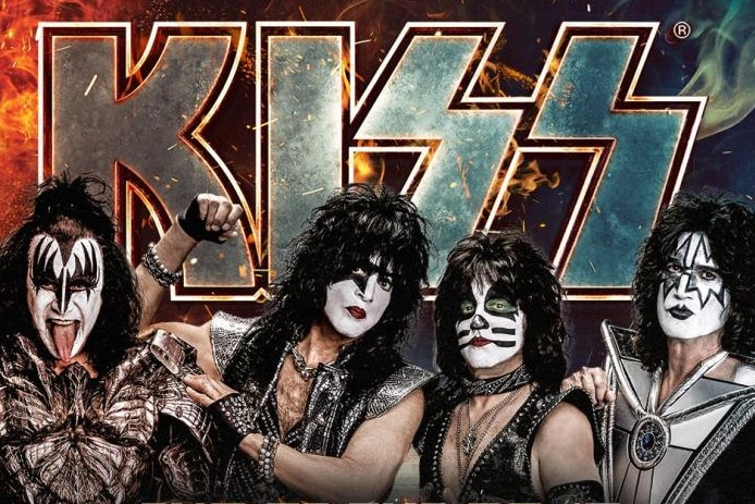 four band members in black and white facepaint in front of the word 'Kiss'