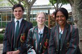 Three graduating high school students in their blazers