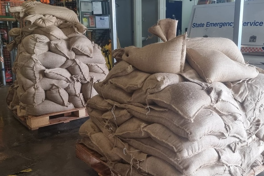 Piles of sand bags on palettes in a shed
