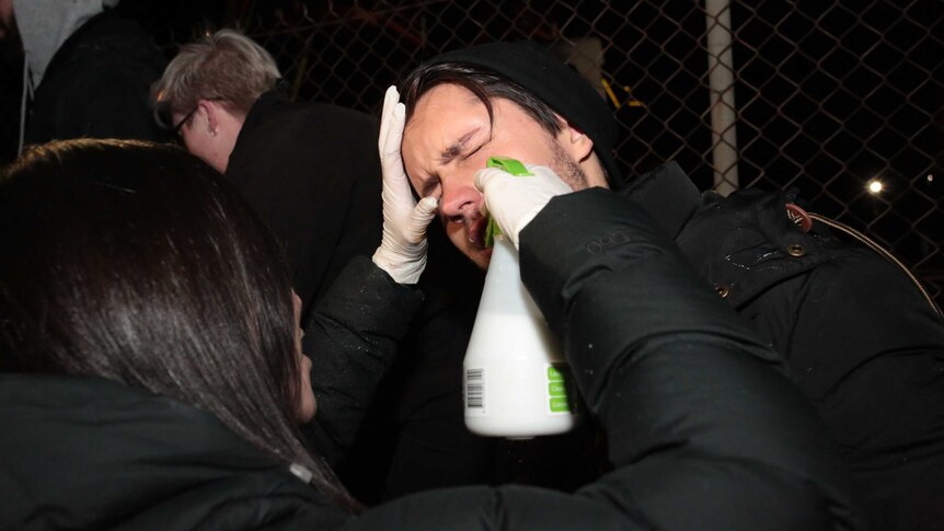 A protester is treated for pepper spray