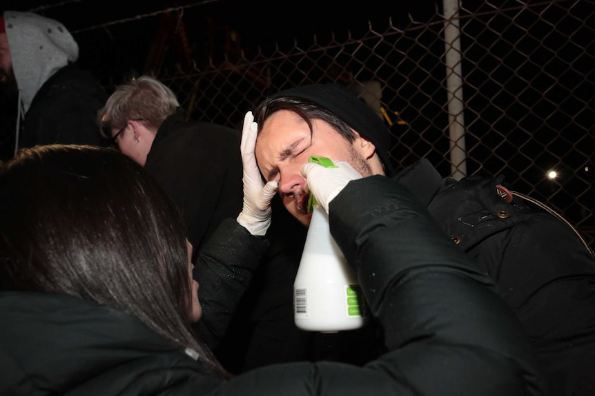 A protester is treated for pepper spray