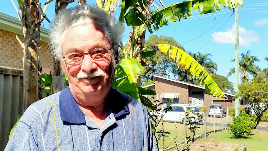 Jerry Lovatt stands in front of banana plants
