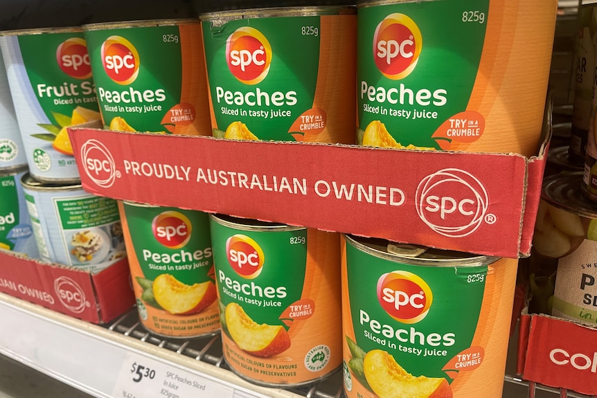 tinned peaches on a supermarket shelf