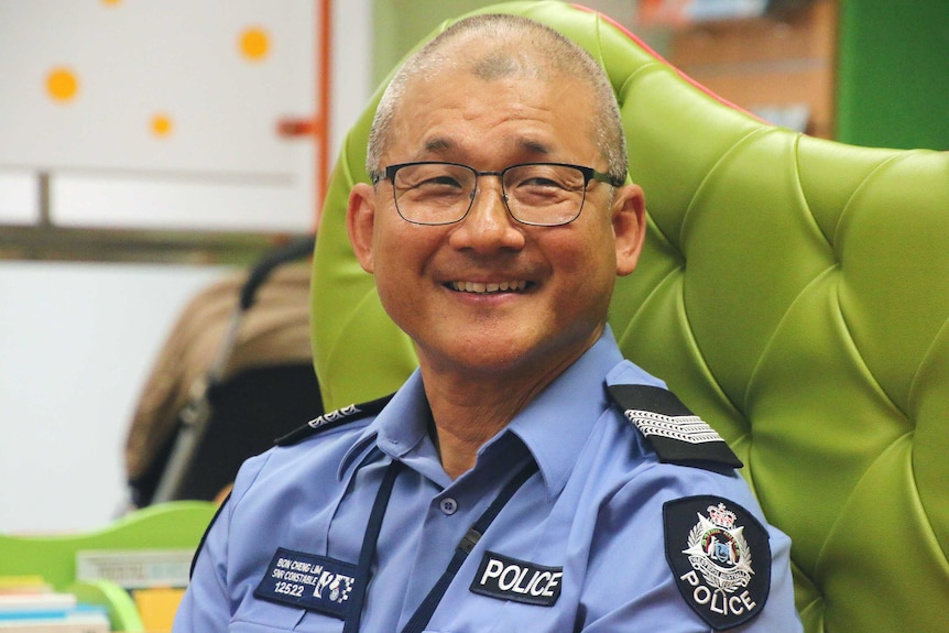 Police officer sitting on green arm chair