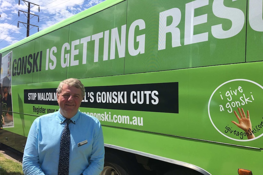 Rob shepherd stands with the Gonski campaign bus