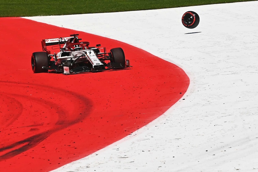 Kimi Raikkonen's Alfa Romeo off the track with a tyre bouncing away.