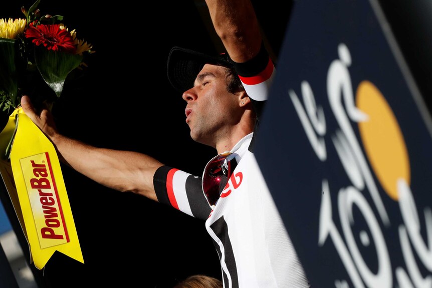 Michael Matthews raises his arms on the podium after winning stage 14 of the Tour de France.