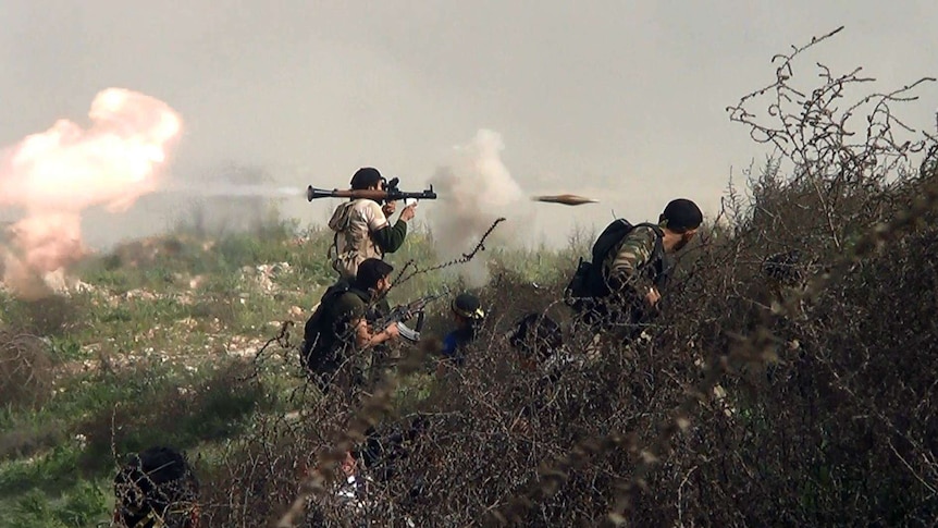 A rebel fighter fires an RPG in Syria