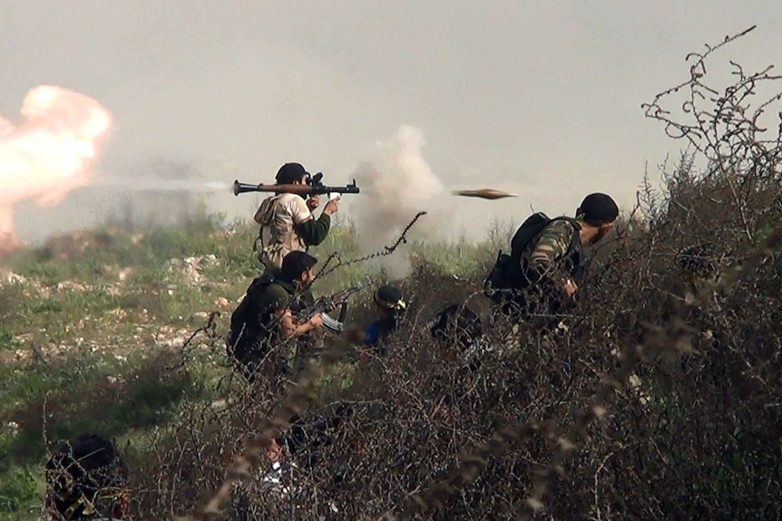 A rebel fighter fires a rocket-propelled-grenade during the ongoing fighting in Syria.