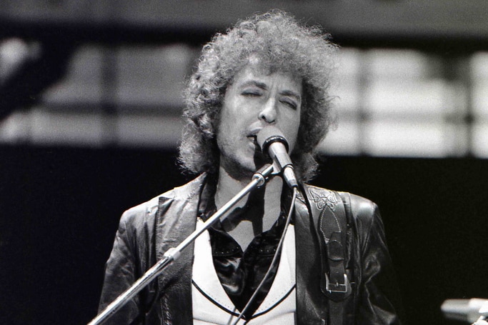 Musician Bob Dylan performing live on a electric guitar