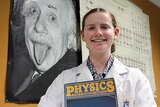 Erica Coxon holding a physics book.