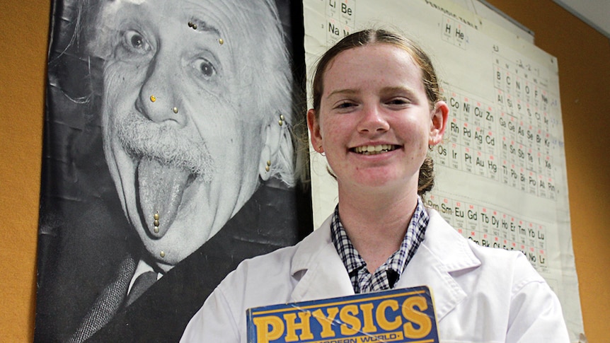 Erica Coxon holding a physics book.