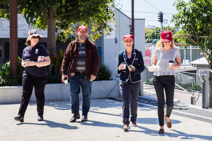 A coffee trail group walking back their office