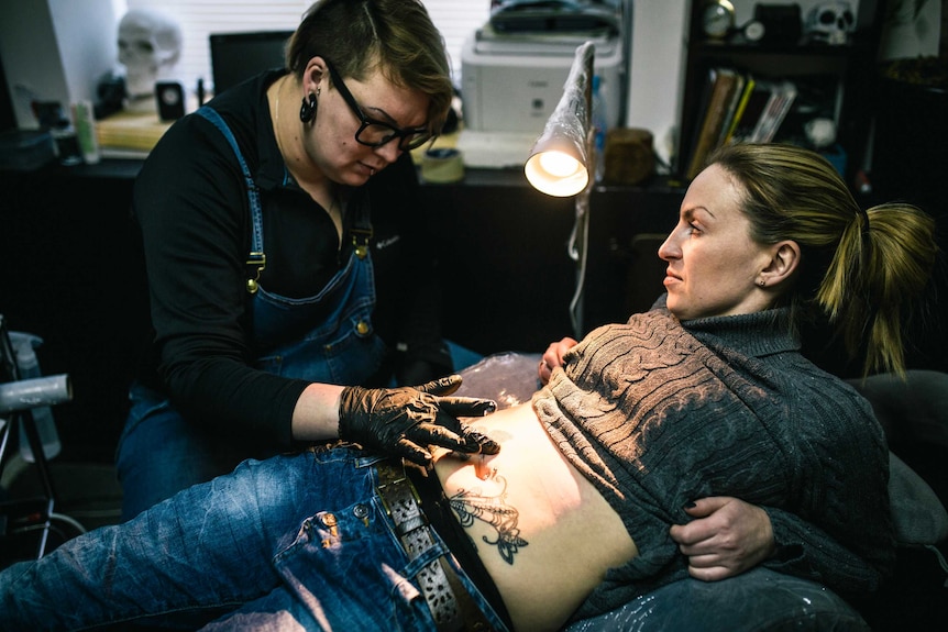 Tattoo artist helps women heal scars of domestic violence