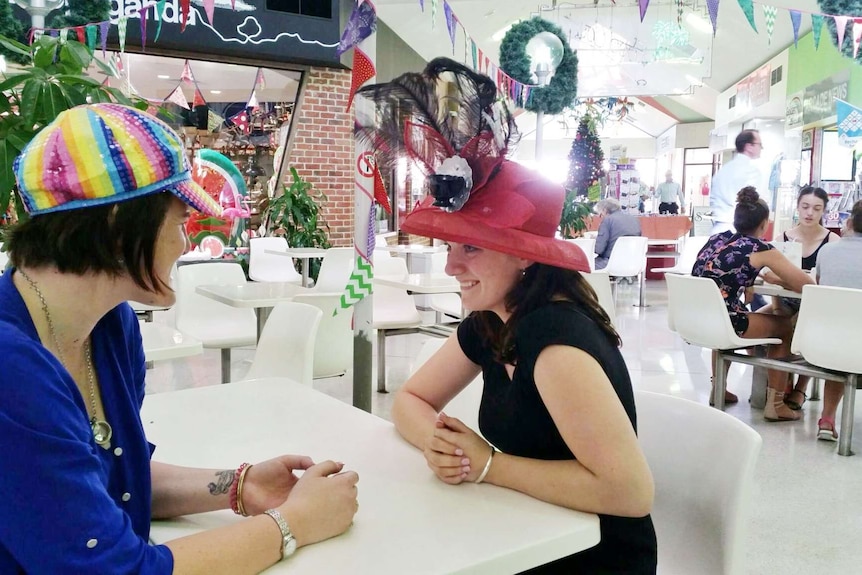 Lauren Thompson and Janae Cariage wearing colourful hats