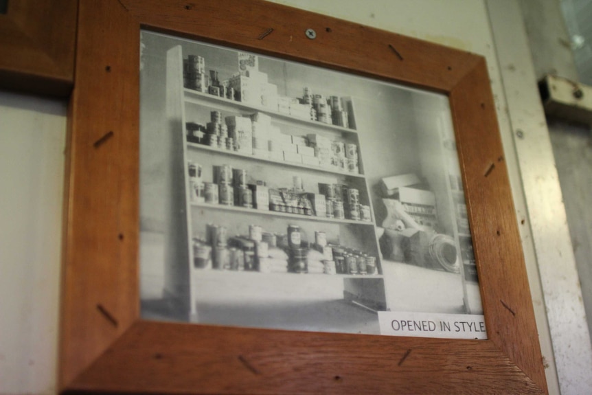 an old photograph in a frame of a set of shop shelves