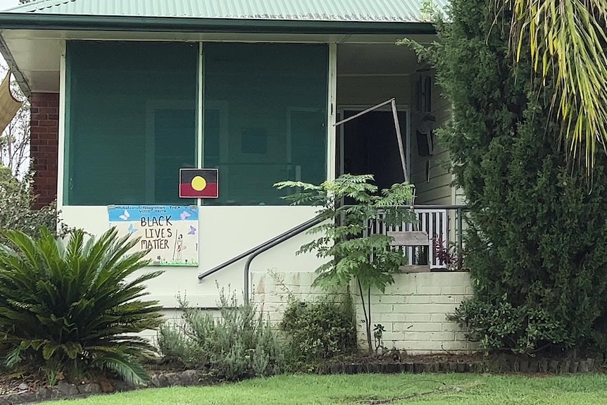 the outside of a house showing an aboriginal flag