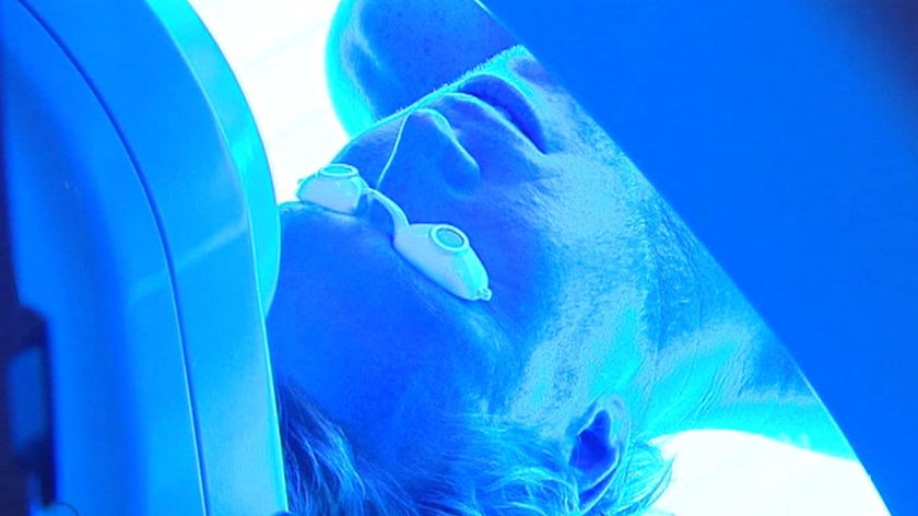A man in a tanning bed