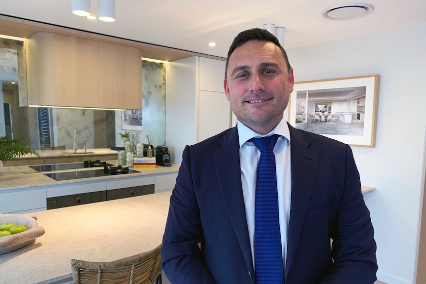 A man stands in a new apartment