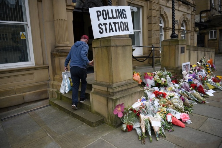 People pass floral tributes to murdered MP Jo Cox outside Batley Town Hall