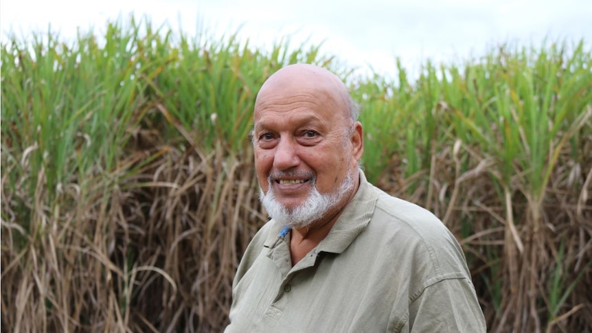 Close-up photo of Adbul Ghani Mohammed standing in front of his cane paddock.