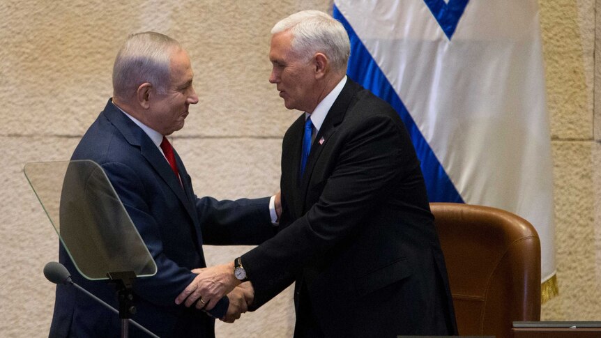 Israel's Prime Minister Benjamin Netanyahu, left, shake hands with US Vice President Mike Pence 