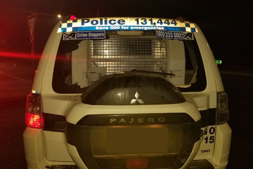 A police car with a broken back window.