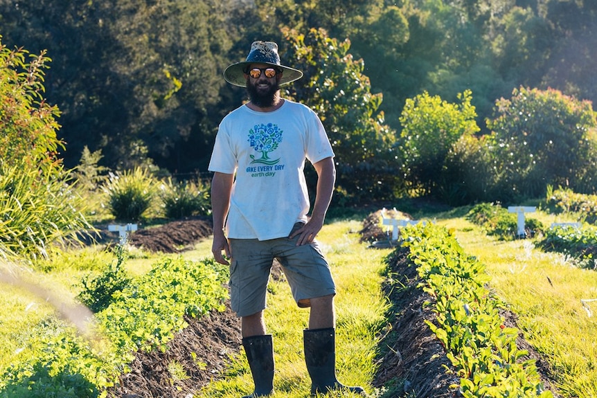 Arran Heideman stands among the produce