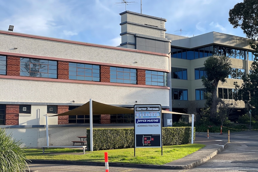 A building with a Harvey Norman out the front.