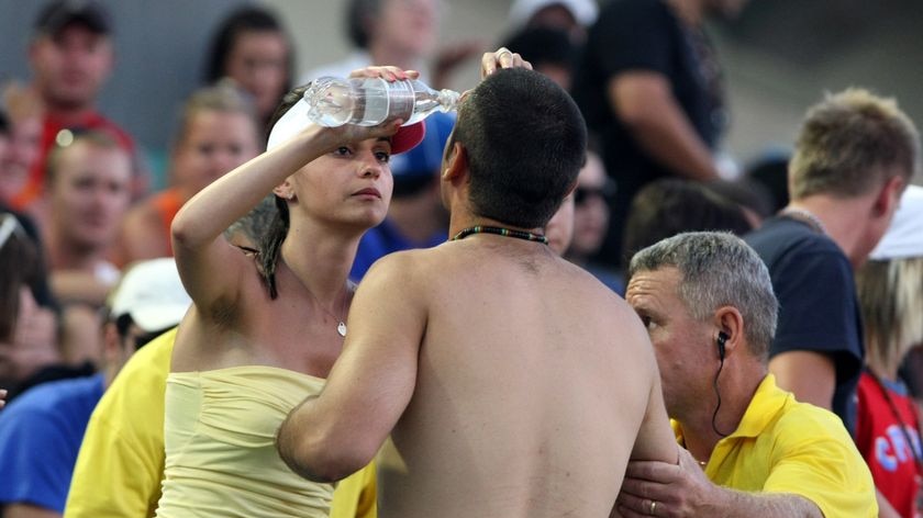 A tennis fan has his face washed after capsicum spray was used by police