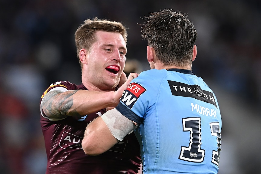 Cameron Munster of the Queensland Maroons and Cameron Murray of the NSW Blues push each other during State of Origin.