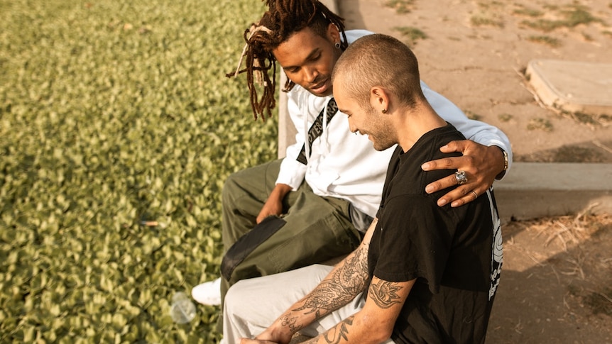 Two men having a chatting outside for a story about getting support for guilt after a loved one's suicide