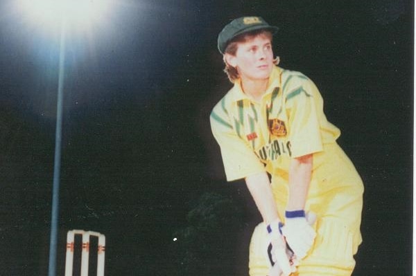 Cricketer Lyn Larsen faces up with bat in hand in her Australian uniform