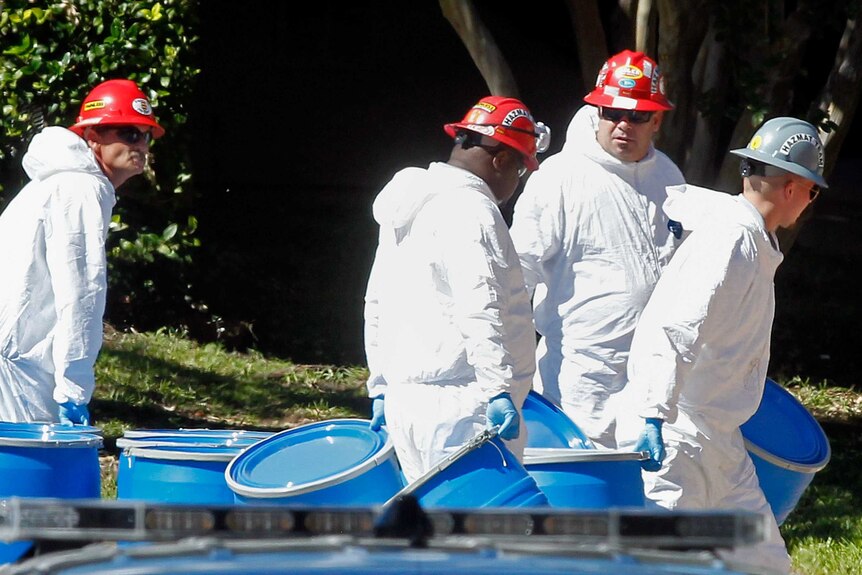 Hazmat workers decontaminate an apartment where the second US health care worker suffering ebola lives on October 15, 2014.