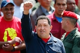 Venezuelan president Hugo Chavez waves to supporters after casting his vote during the election in Caracas.