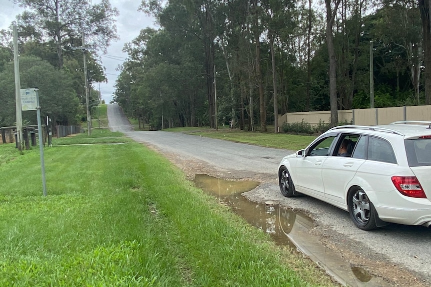 White car near bust stop on Ritchies Rd, Pallara