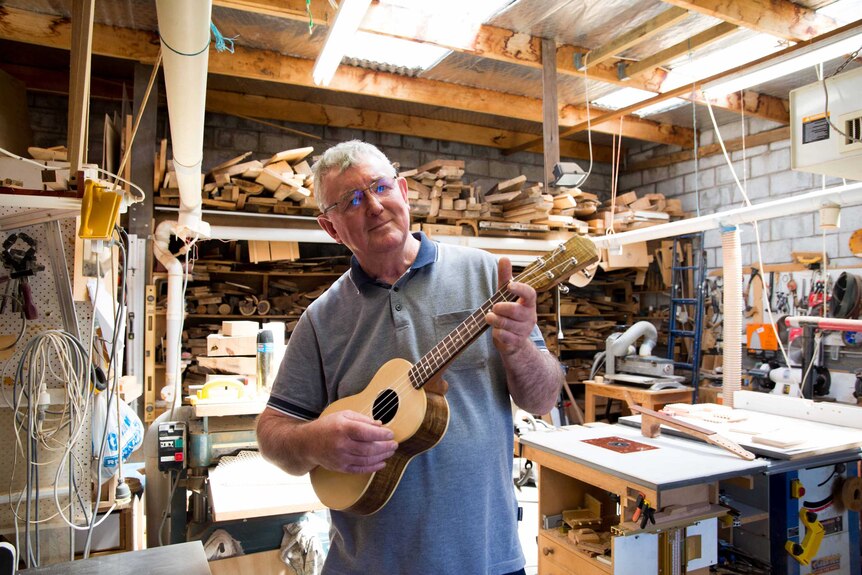 Pat Hawkins, in his Tasmanian workshop with his homemade ukulele, December 2017
